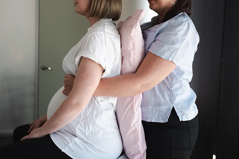 osteopath assessing pregnant patient with posture