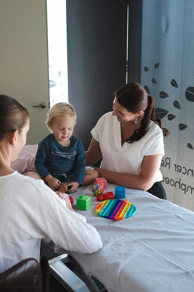 osteopath explaining treatment process to child