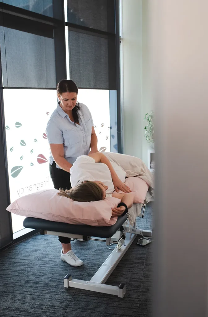 pregnant woman receiving gentle back treatment